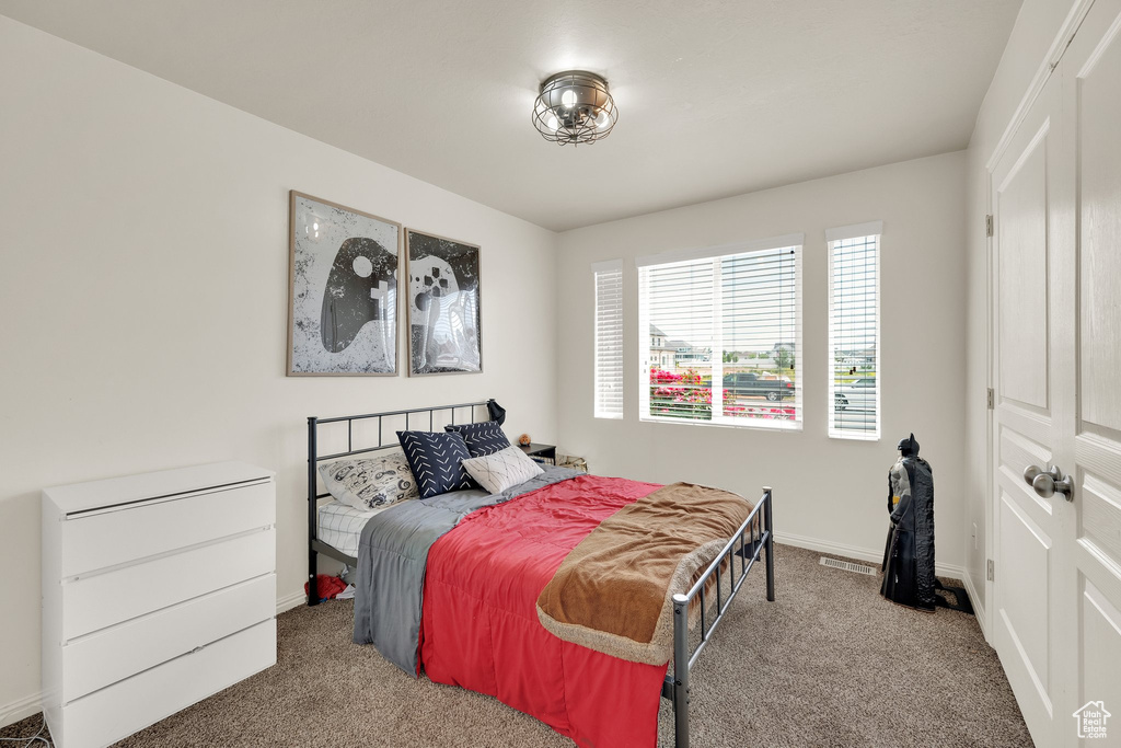 Bedroom with carpet and baseboards