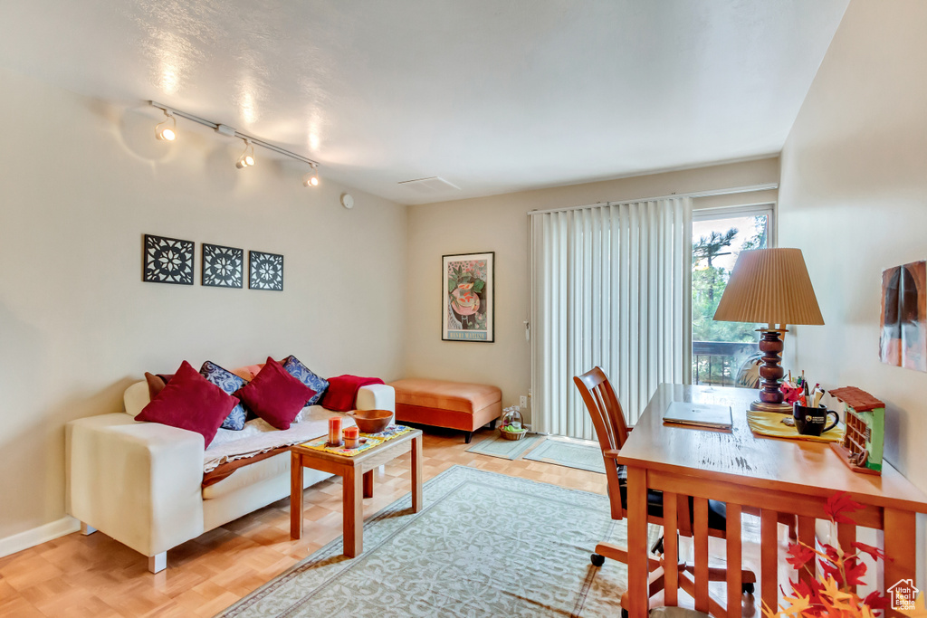 Living area featuring baseboards and track lighting