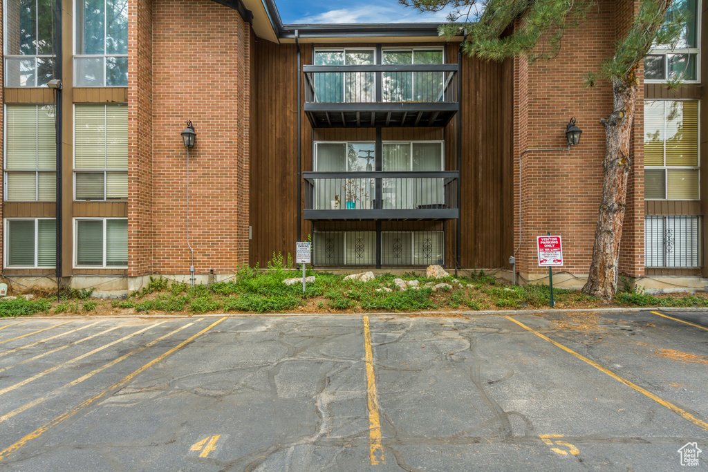 View of building exterior featuring uncovered parking