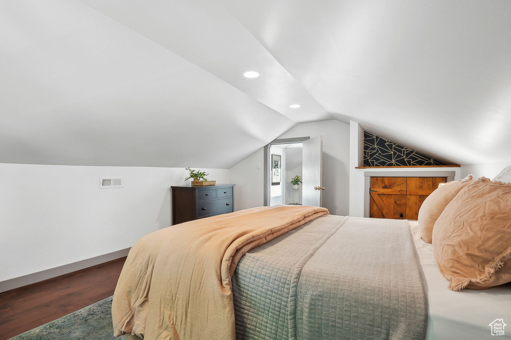 Bedroom featuring wood finished floors, recessed lighting, and vaulted ceiling
