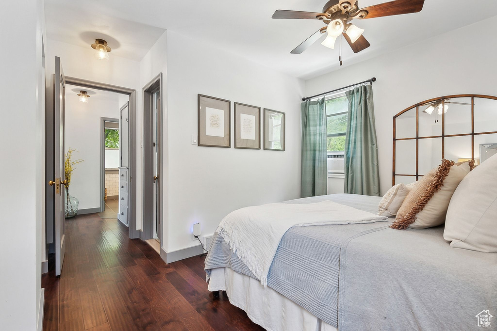 Bedroom with wood finished floors, baseboards, and ceiling fan