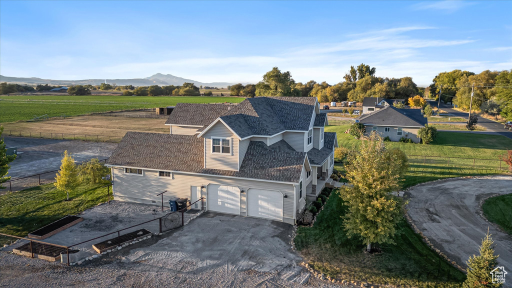 Aerial view of property and surrounding area featuring a mountain backdrop