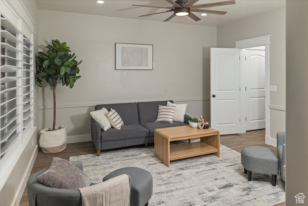 Living area with ceiling fan, wood finished floors, and recessed lighting