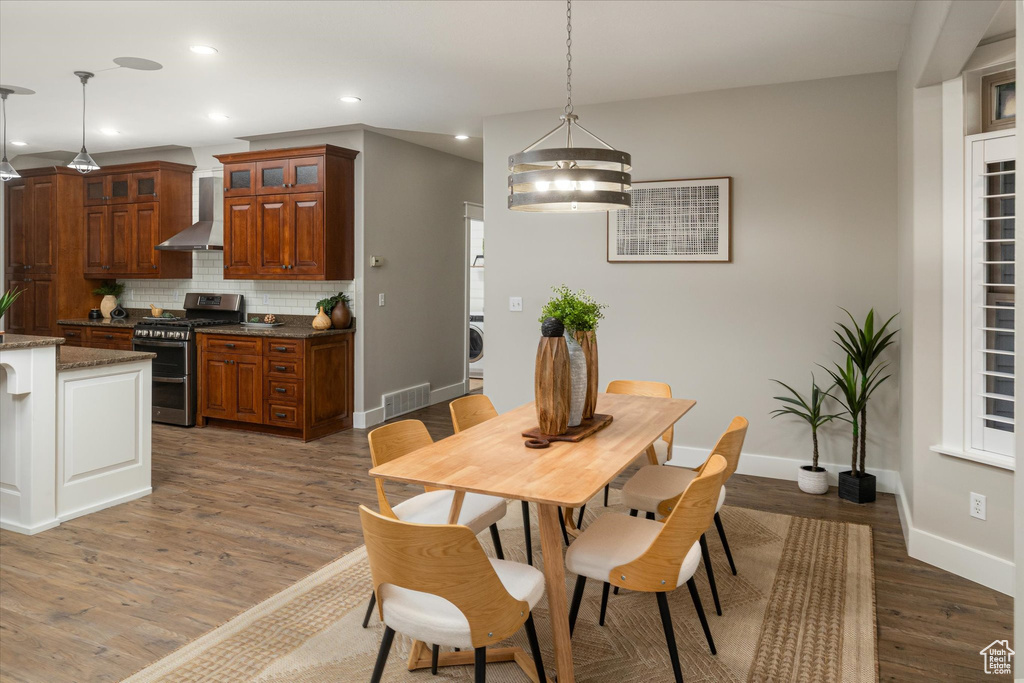 Dining space with light wood-type flooring, baseboards, recessed lighting, and washer / clothes dryer