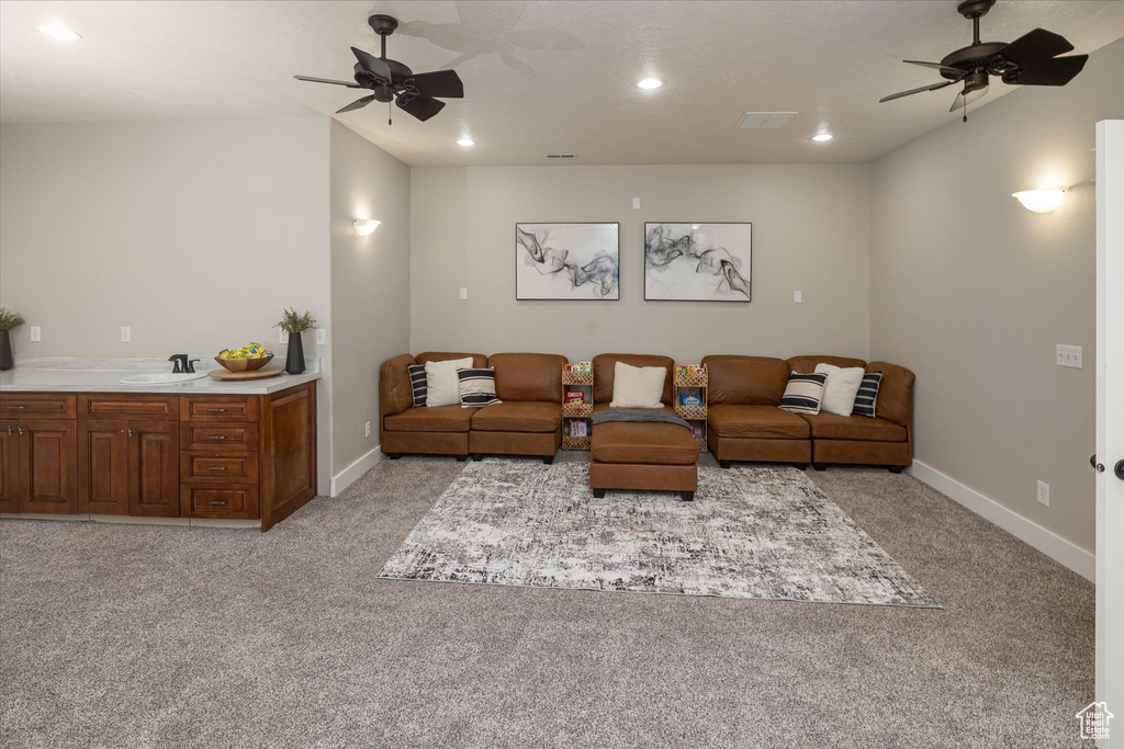 Living room with a ceiling fan, light colored carpet, recessed lighting, and baseboards