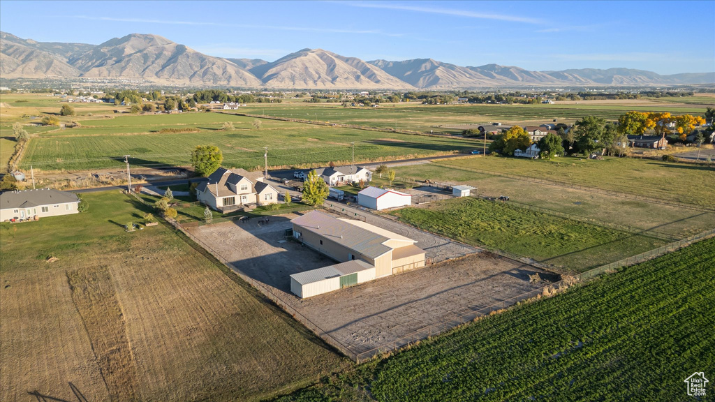Aerial view of sparsely populated area with a mountainous background and extensive farmland
