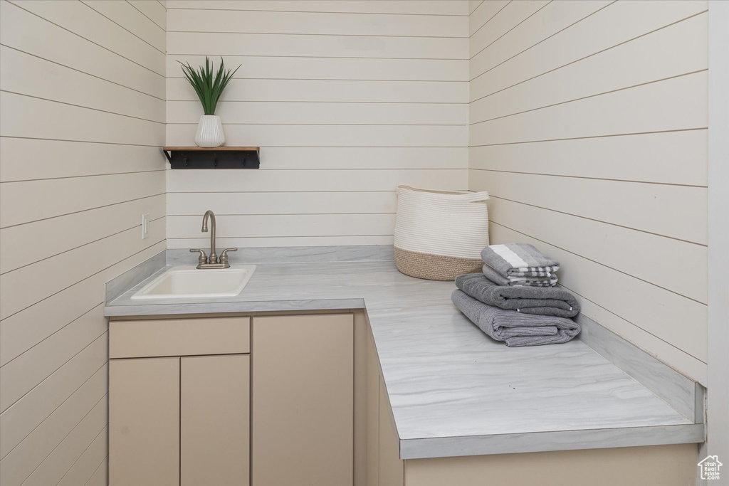 Bathroom featuring wood walls and vanity