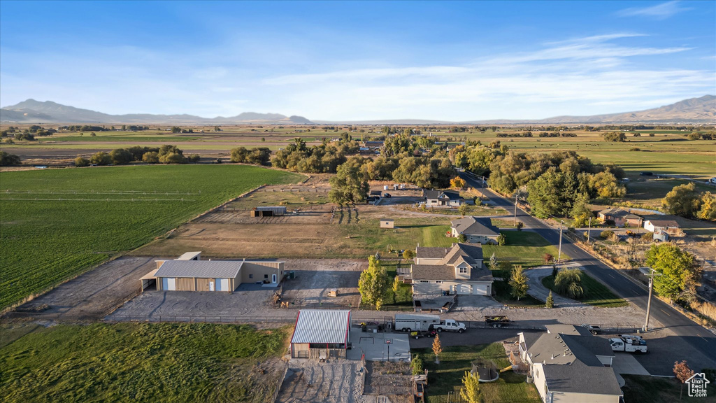 Aerial view of property and surrounding area featuring mountains and rural landscape