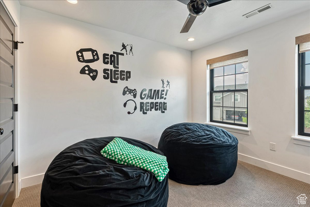 Living area featuring baseboards, a ceiling fan, carpet, and recessed lighting