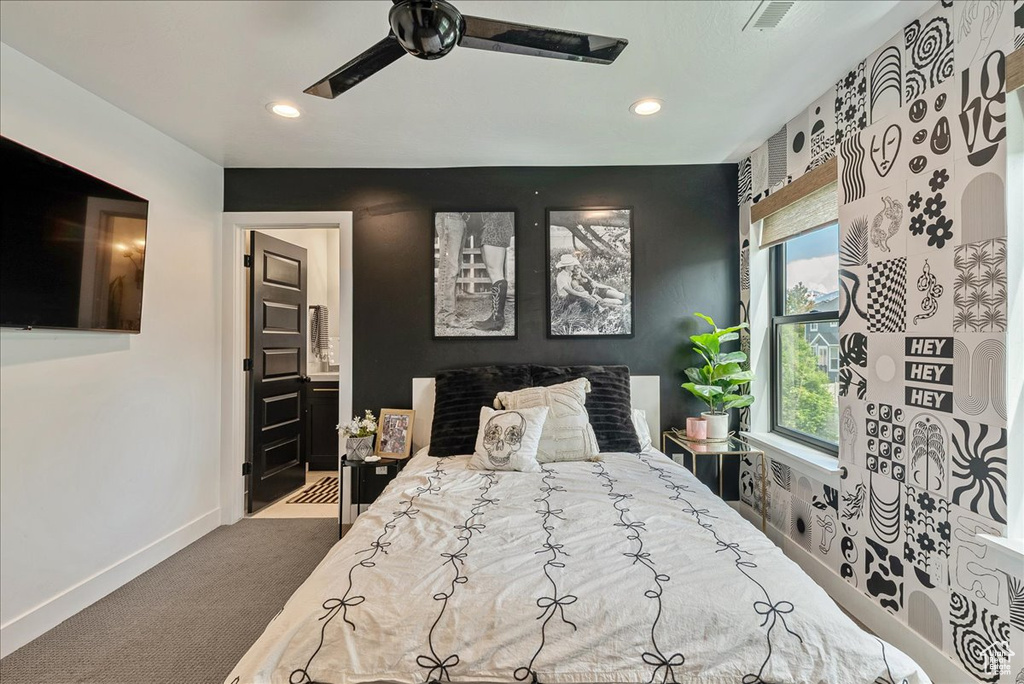 Carpeted bedroom featuring baseboards, recessed lighting, and ensuite bathroom