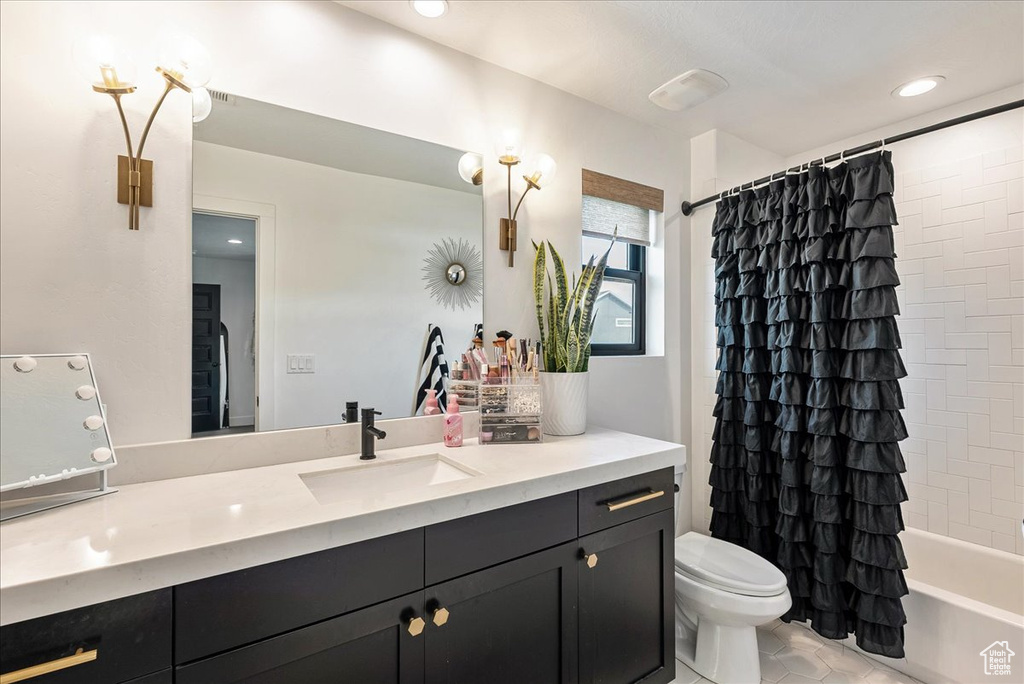 Full bath featuring vanity, toilet, tile patterned floors, shower / tub combo with curtain, and recessed lighting