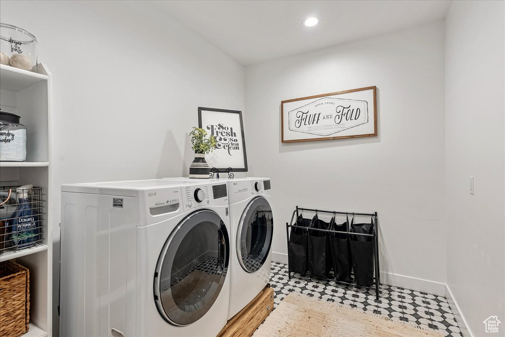 Laundry area featuring washing machine and dryer, baseboards, and recessed lighting
