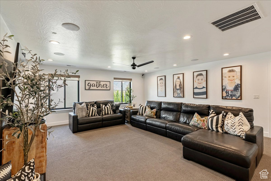 Living area featuring carpet floors, recessed lighting, a ceiling fan, and baseboards