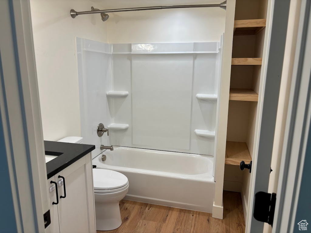 Full bathroom featuring vanity, bathtub / shower combination, and wood finished floors