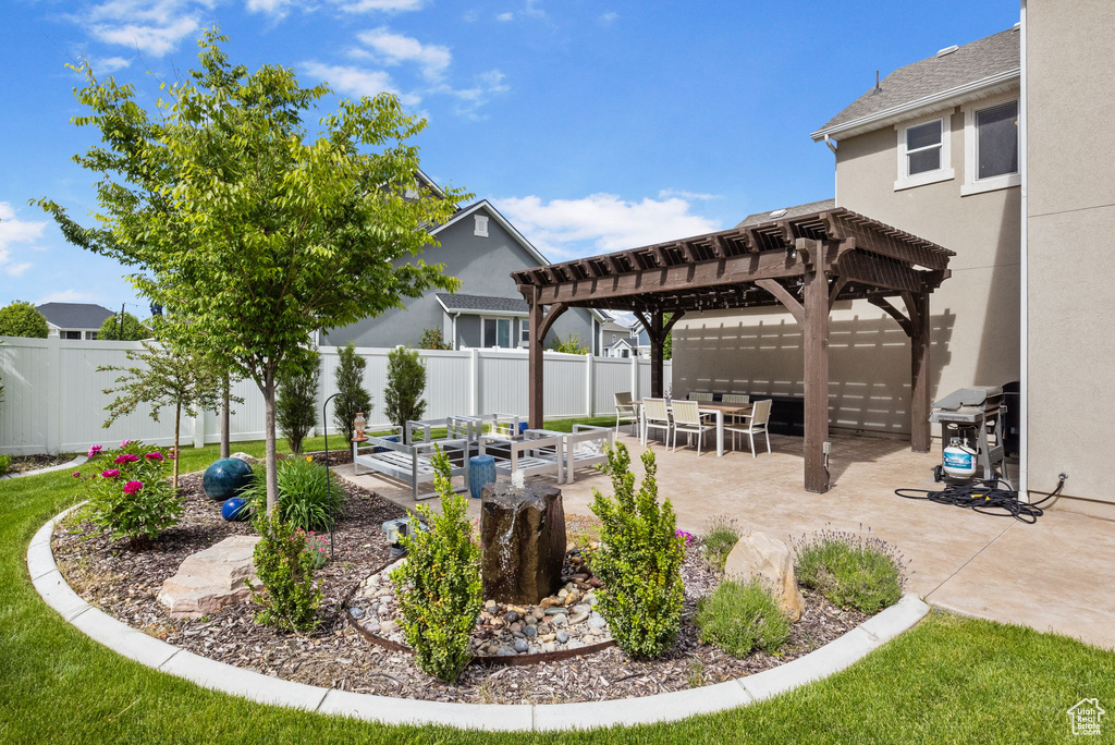 Fenced backyard featuring a pergola, a patio area, and a vegetable garden