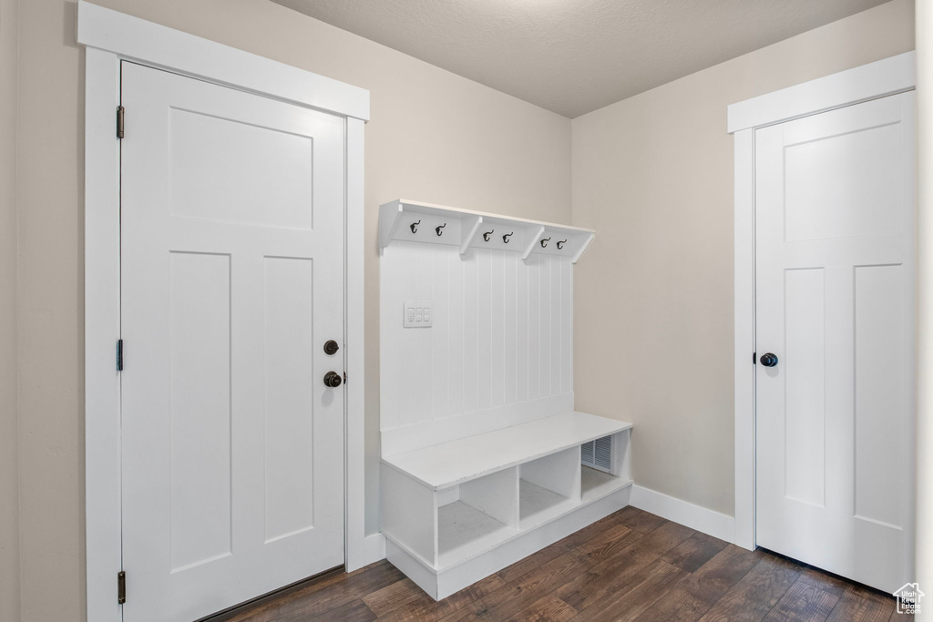 Mudroom with dark wood-style floors and baseboards