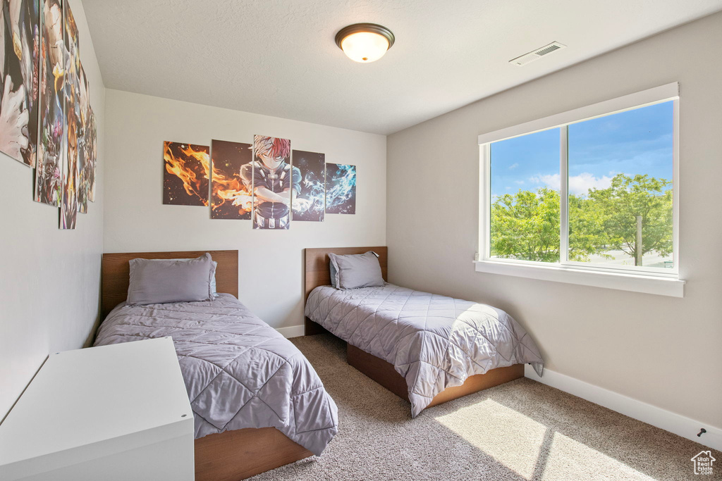 Carpeted bedroom with baseboards