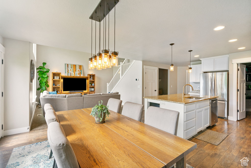 Dining space with stairway, dark wood-type flooring, recessed lighting, and baseboards