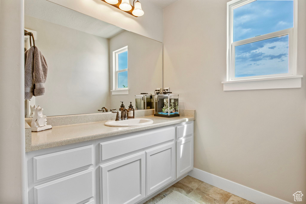 Bathroom featuring vanity and baseboards
