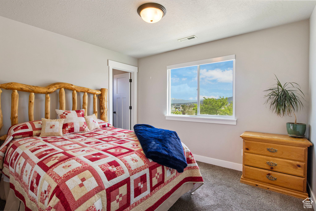 Carpeted bedroom with baseboards