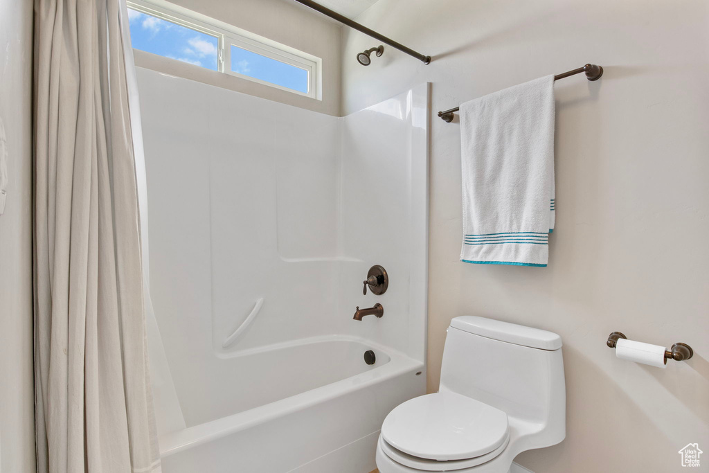 Full bathroom with shower / tub combo and toilet