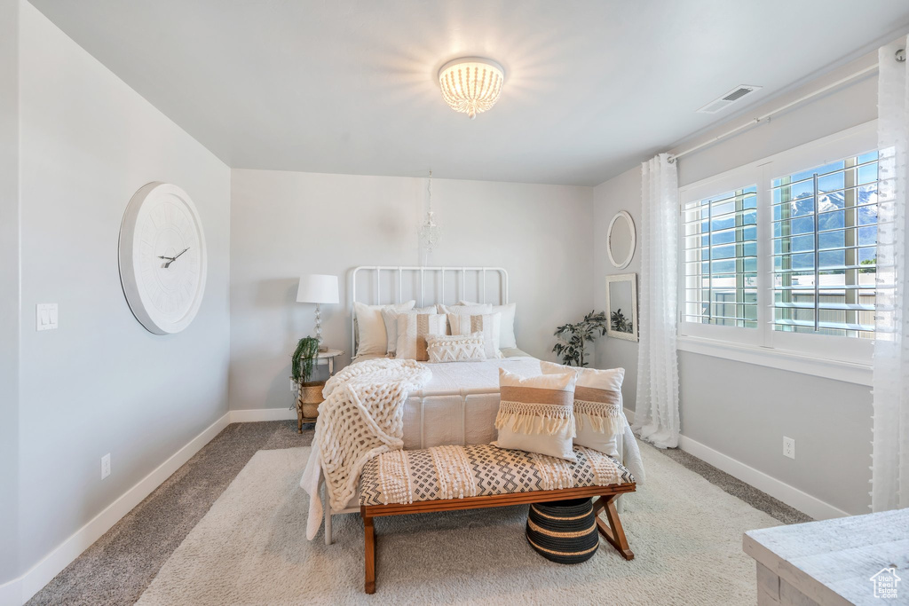 Bedroom featuring carpet and baseboards