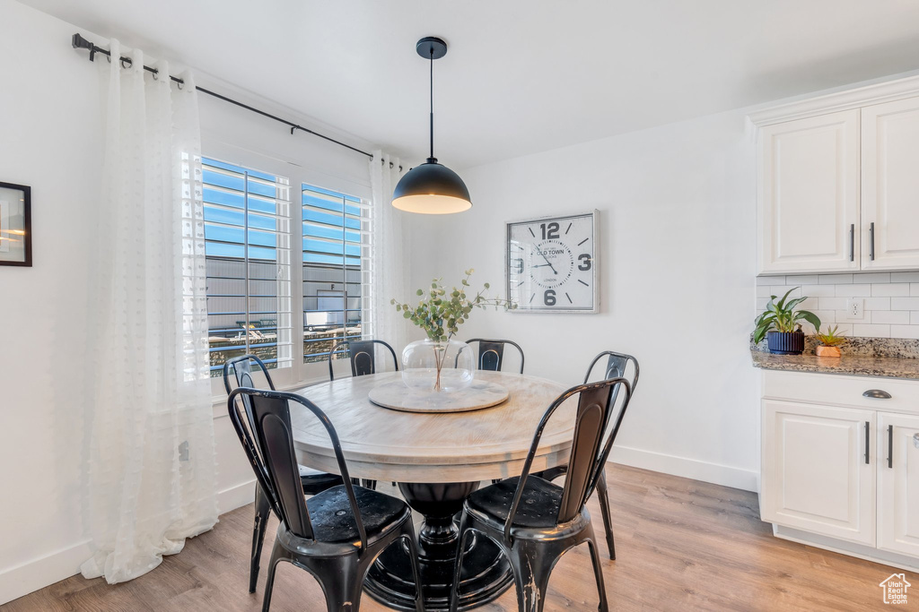 Dining room with light wood-style floors and baseboards