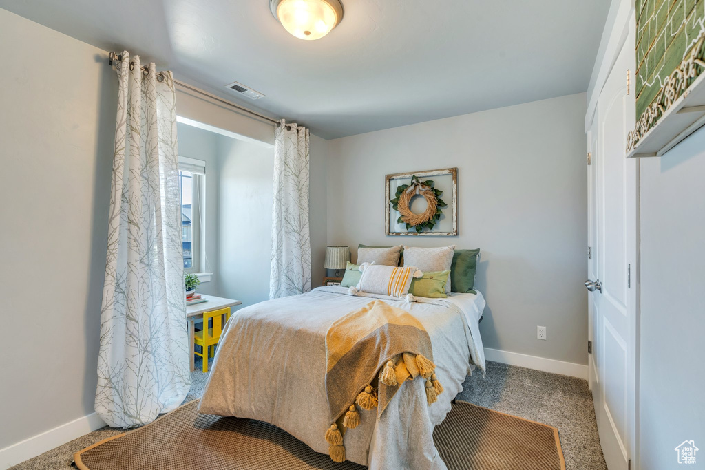 Bedroom with baseboards and carpet