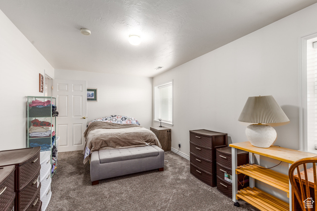 Carpeted bedroom featuring baseboards