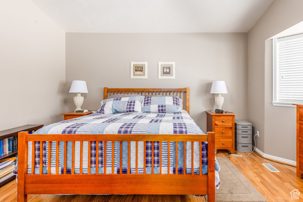 Bedroom featuring wood finished floors and baseboards