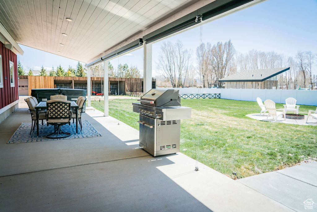 View of patio / terrace with grilling area, an outdoor fire pit, and outdoor dining space
