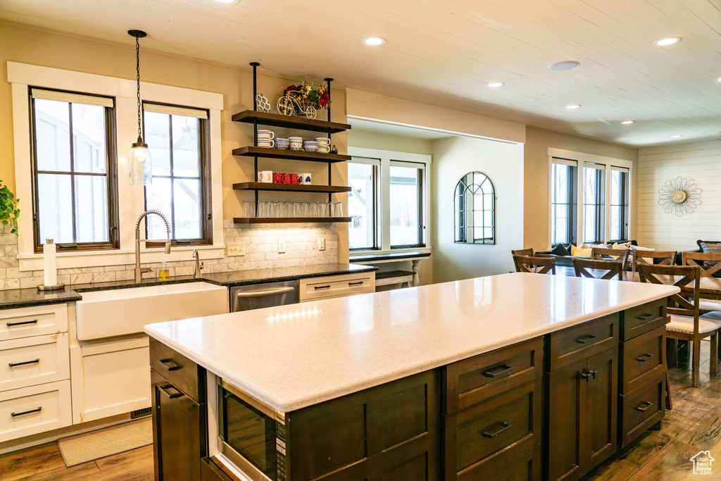 Kitchen with recessed lighting, stainless steel microwave, dark wood-type flooring, tasteful backsplash, and wooden ceiling
