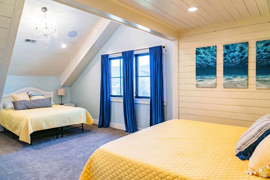Bedroom featuring carpet, a chandelier, vaulted ceiling, wood walls, and recessed lighting