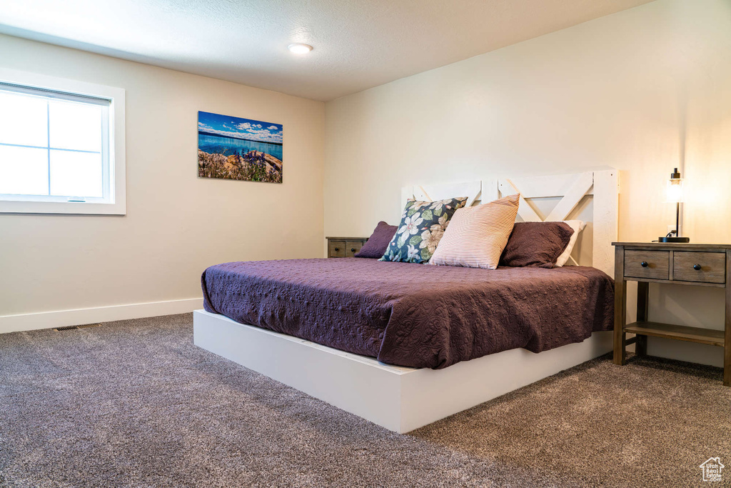 Carpeted bedroom with baseboards