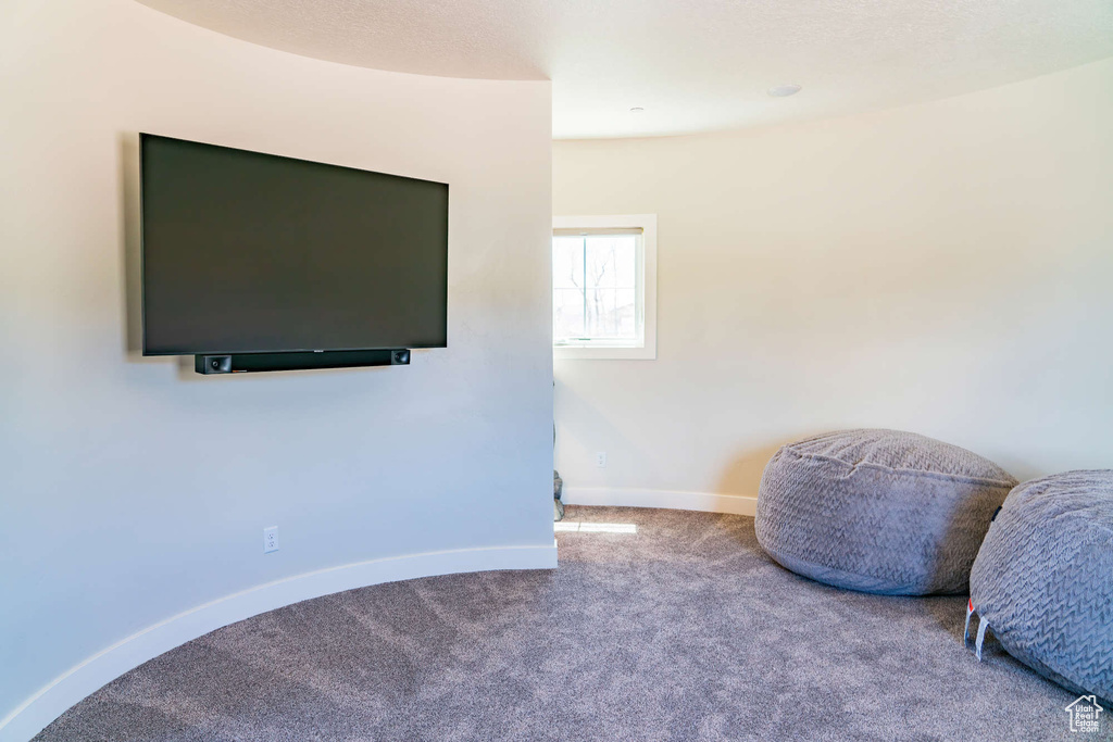 Sitting room featuring carpet and baseboards