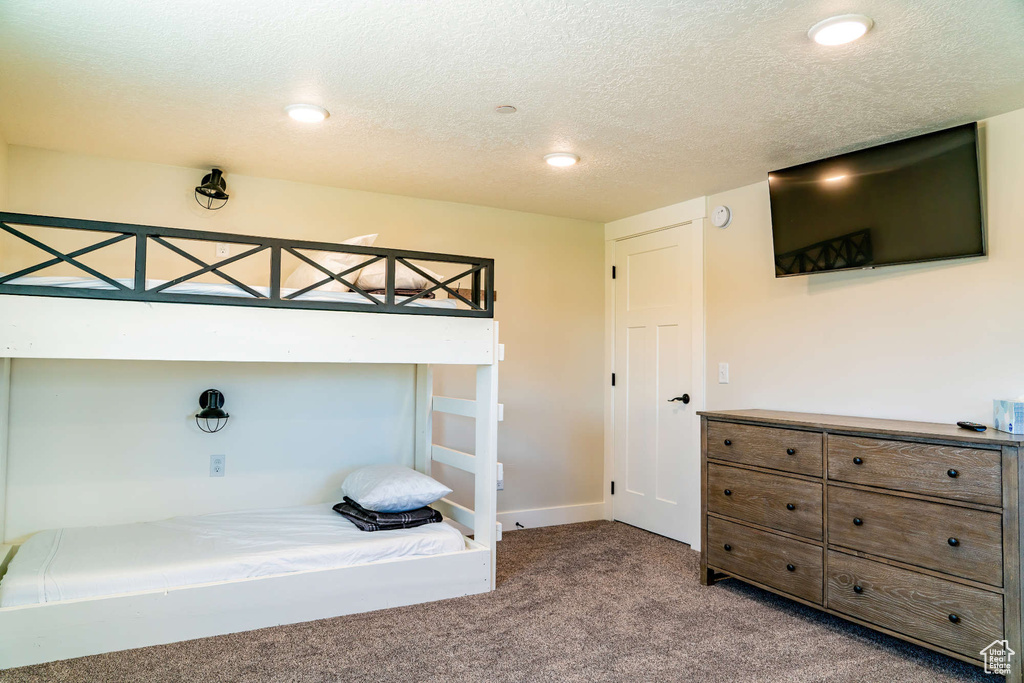 Bedroom featuring carpet floors, a textured ceiling, baseboards, and recessed lighting