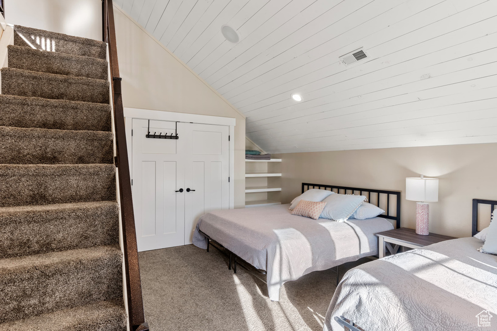 Carpeted bedroom with lofted ceiling, wooden ceiling, and recessed lighting
