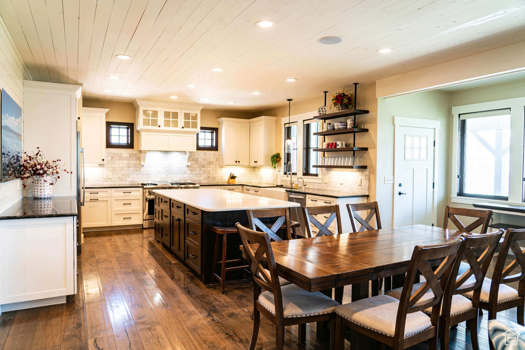 Dining area featuring recessed lighting, dark wood-type flooring, plenty of natural light, and wood ceiling