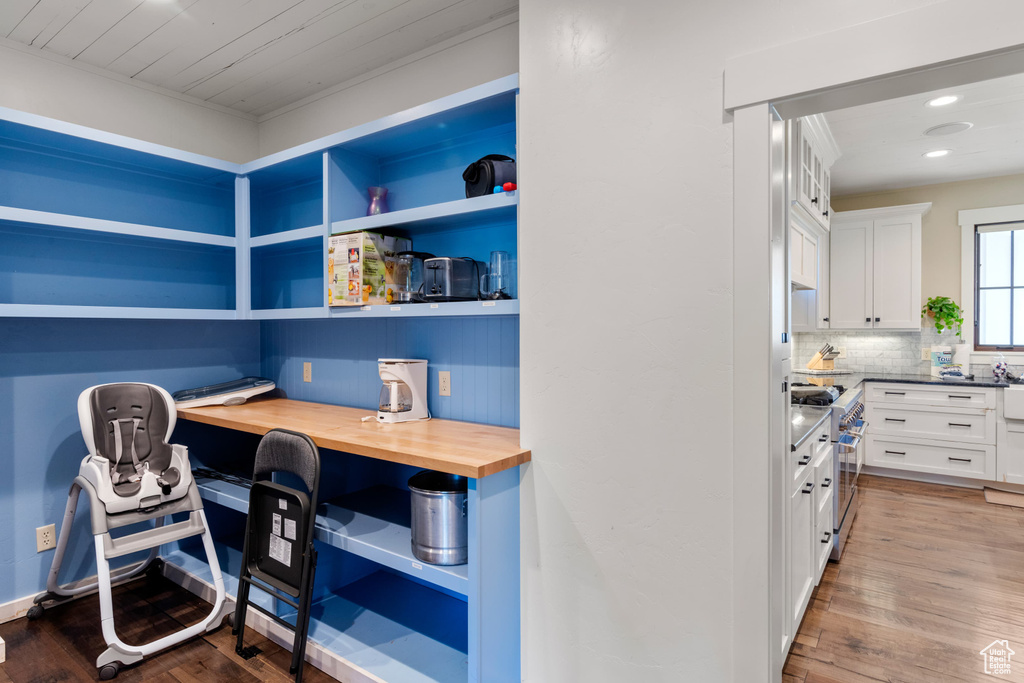 Office featuring built in study area, wood finished floors, and recessed lighting
