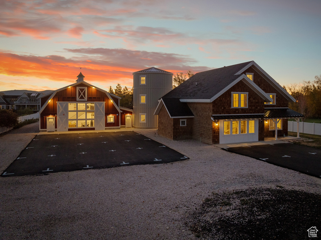 View of front of house featuring a barn and an outbuilding