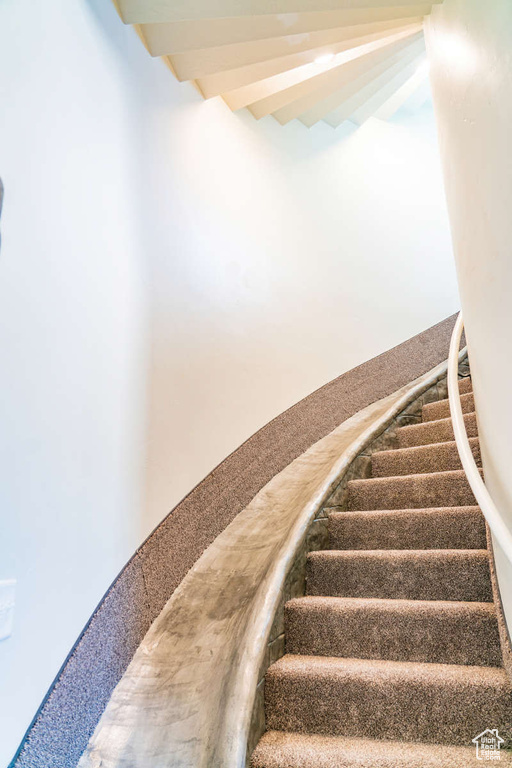 Stairway featuring beam ceiling