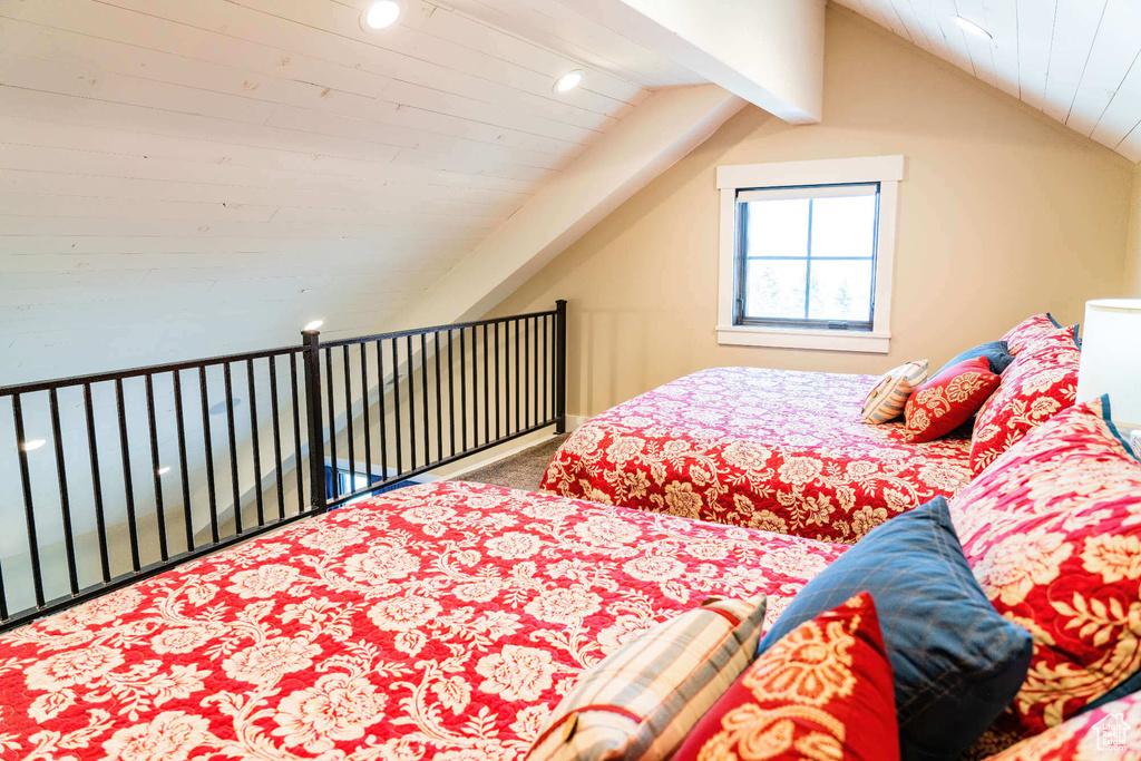 Carpeted bedroom featuring vaulted ceiling and recessed lighting