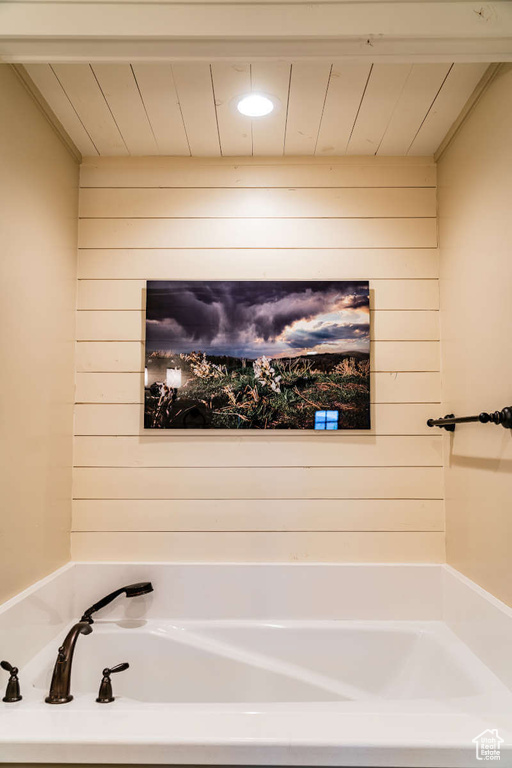 Full bathroom with wood walls, a garden tub, and wooden ceiling