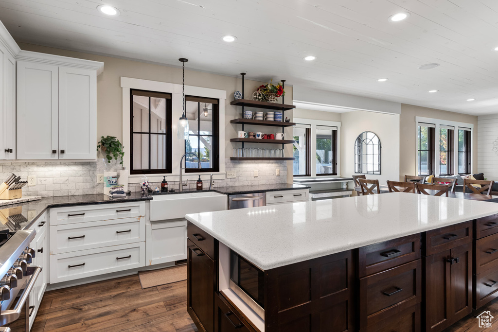 Kitchen featuring recessed lighting, a sink, dark brown cabinetry, appliances with stainless steel finishes, and backsplash