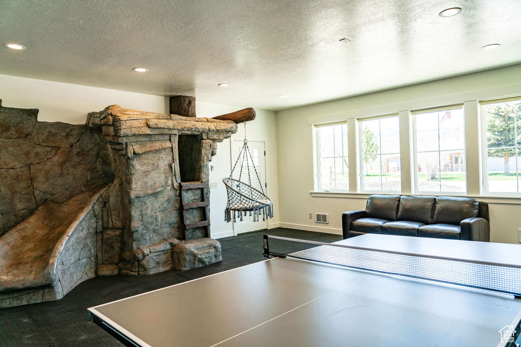 Playroom featuring a textured ceiling, recessed lighting, and baseboards