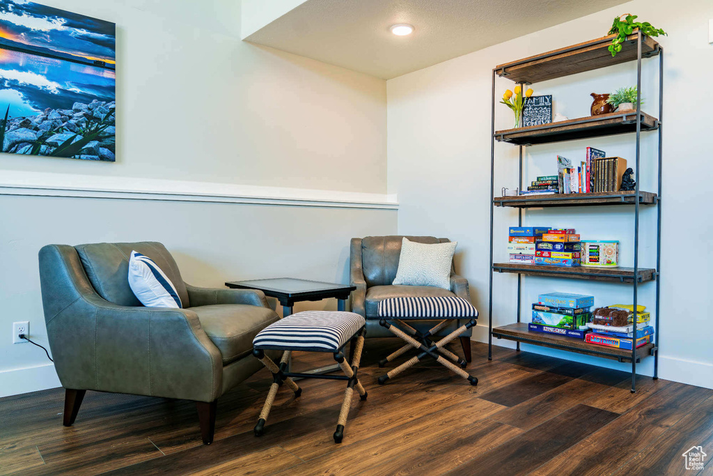 Living area with wood finished floors, baseboards, and recessed lighting
