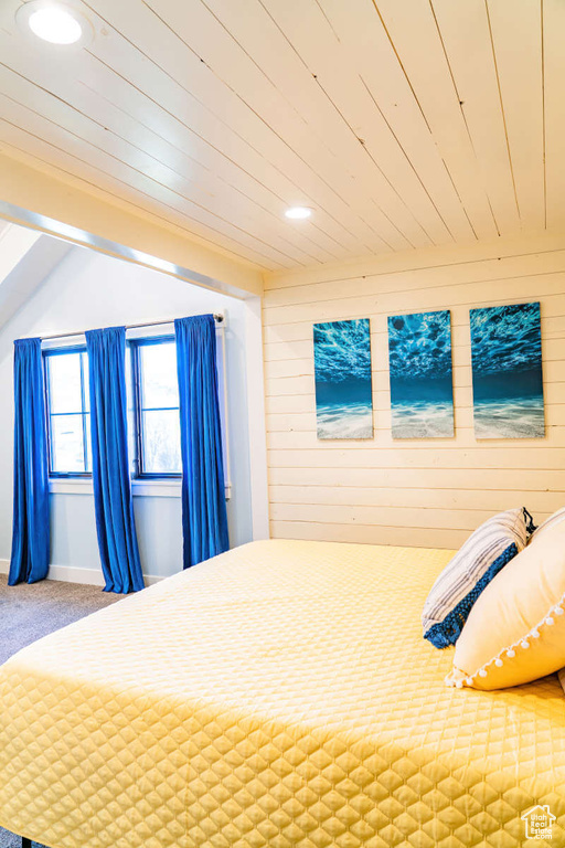 Unfurnished bedroom featuring recessed lighting, wooden walls, carpet, and wooden ceiling