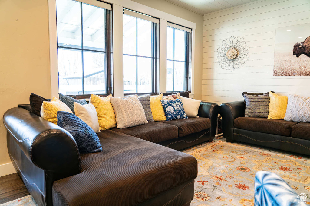 Living room featuring wooden walls and wood finished floors