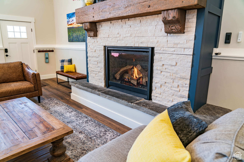 Living area featuring wood finished floors, baseboards, and a fireplace