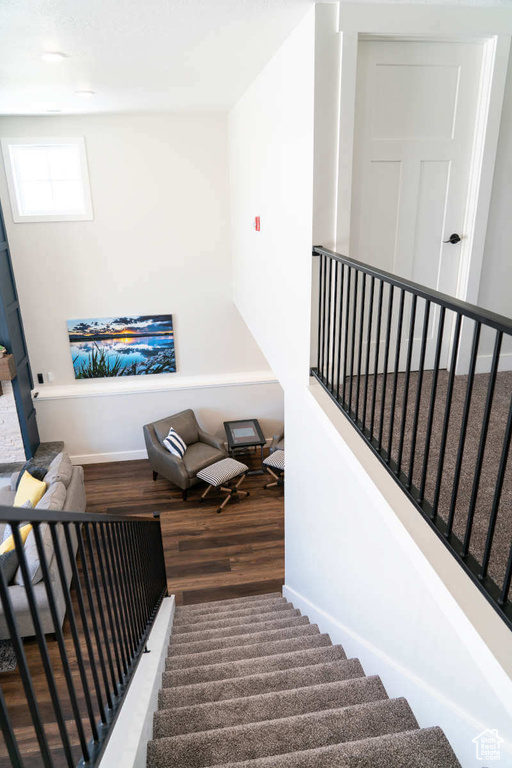 Staircase featuring wood finished floors and baseboards